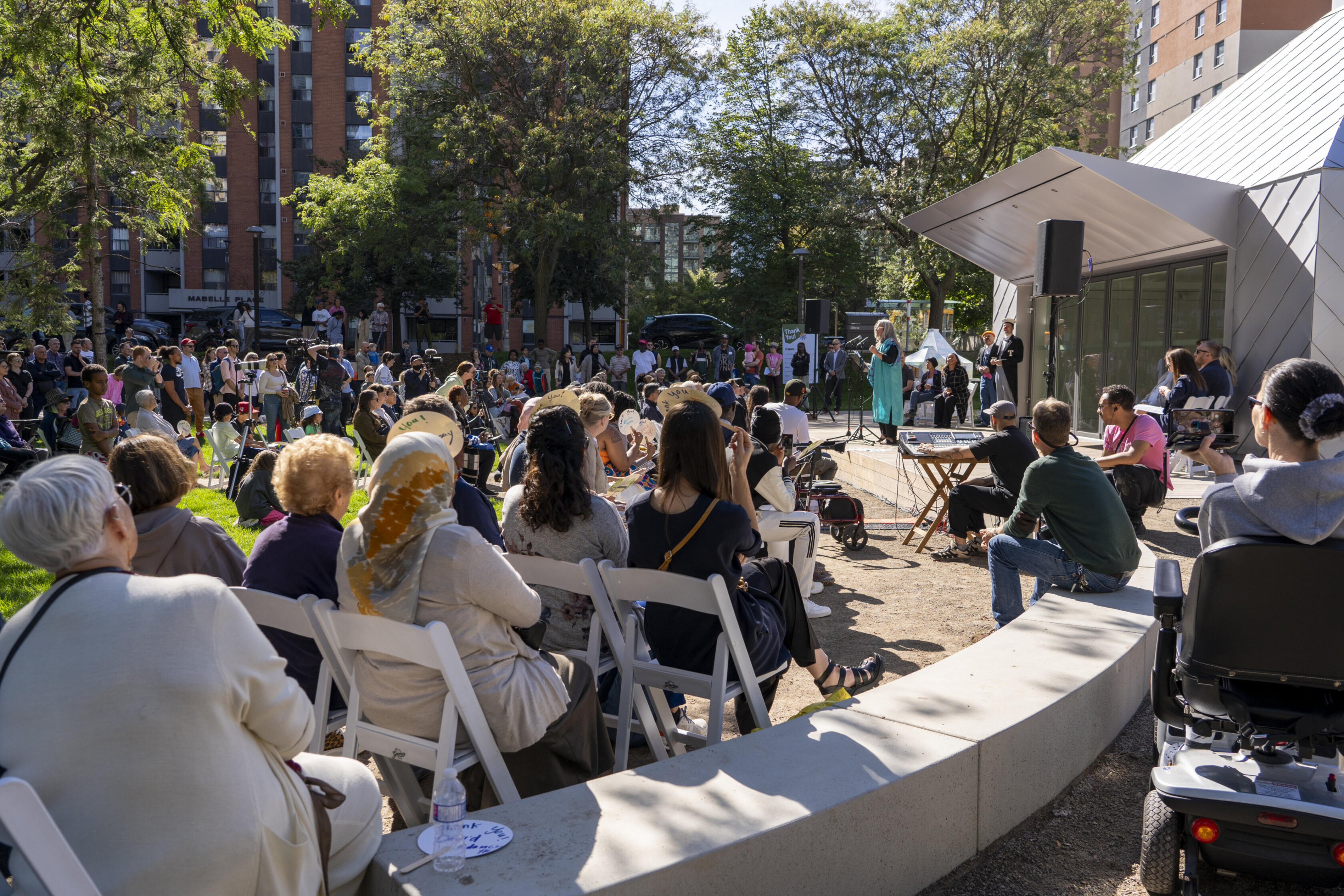 Leah Houston, the Founder and Executive Director of Mabelle Arts, speaking to all those gathered to celebrate the new Mabelle Park. Photo: Katrin Faridani